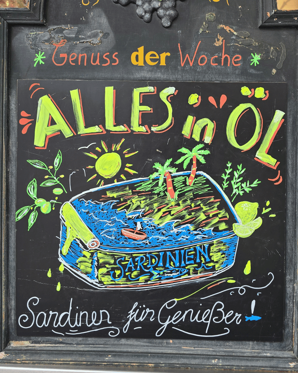 Kreidetafel für Sardinen in Olivenöl. Alles in Öl mit einer geöffneten Dose Sardinen mit Sonne, Palmen und Meer in Mannheim